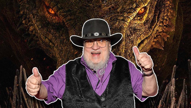 George R.R. Martin stands in front of a dragon and gives a thumbs up.